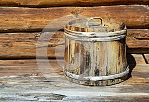 old wooden tub with lid. container made of wooden planks and covered with hoops. vintage barrel for products