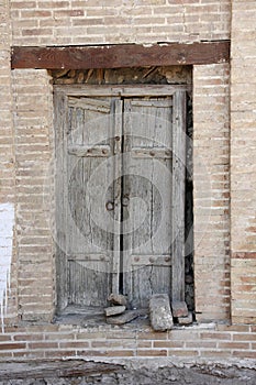 Old wooden tumbledown door in the Central Asian style