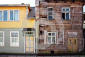 Old wooden two story apartment building around 1940-1950, one side is renovated and the other abandoned.