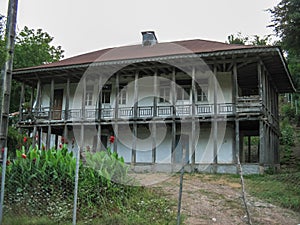 Old wooden village house in Iran. Beautiful rural house With gable roofs and wooden porch in front of the house