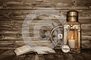 Old wooden vintage background with book, lantern and nautical de