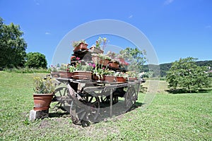 old wooden wagon decorated with many pots