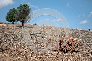 An old wooden wagon with two wheels on a field in Myanmar