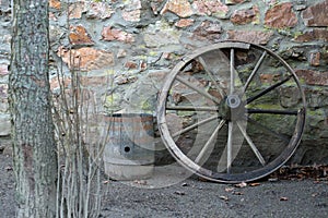 Old wooden wagon wheel and barrel