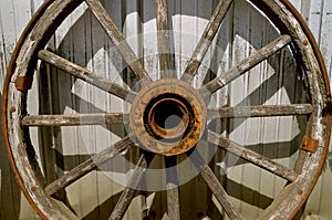 Old wooden wagon wheel with hub and spokes