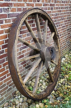 Old wooden wagon wheel with iron rim