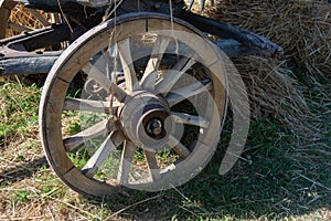 Old wooden wagon wheel with metal strapping