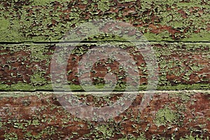 Old wooden wall with green cracked paint. The texture of an old wooden board covered with irradiated paint.