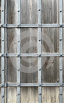 Old wooden wall with metal stripes