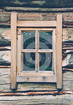 Old wooden wall with a window. Close-up. Ukraine