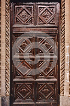 Old wooden weathered door in ancient town architecture