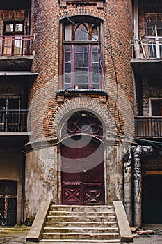 Old wooden weathered door in ancient town architecture