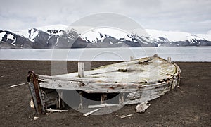 Old wooden whaling boat on the beach at Whaler`s Bay, Antarctica photo