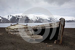 Old wooden whaling boat on the beach at Whaler`s Bay, Antarctica photo