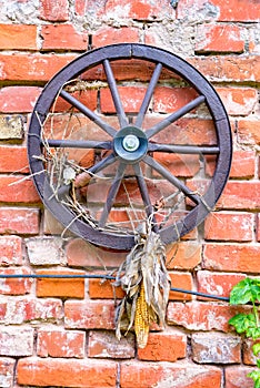 An old wooden wheel hangs on the wall