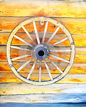 Old Wooden Wheel On wooden wall