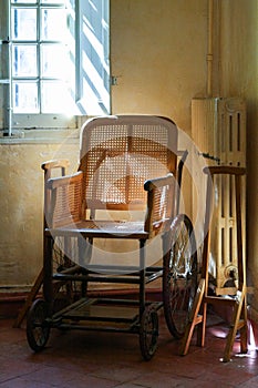 Old wooden wheelchair in the interior.