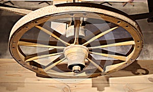 Old wooden wheels from grandfather`s cart are stored in a rustic barn