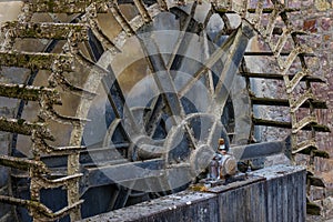 The old and wooden whell of watermill in sunshine