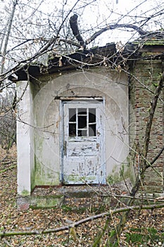 old wooden white door at house entrance in chernobyl