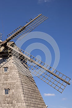 Old wooden wind mill in Lazdininkai village, DarbÄ—nai, Lithuania on a sunny day photographed with a drone.