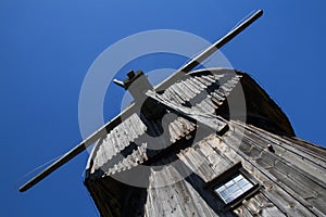 Old Wooden windmill against blue sky