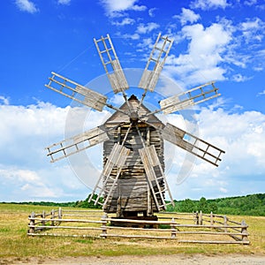 Old wooden windmill against the sky.