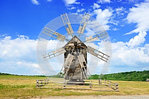 Old wooden windmill against the sky.