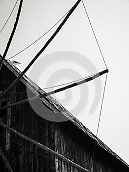 Old wooden windmill in the background of the blue sky