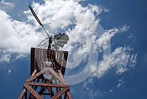 Old Wooden Windmill and Cloudy Sky