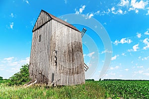 Old wooden windmill in cornfield