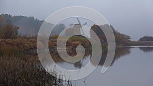 Old wooden windmill on a foggy October morning. Mikhailovskoe, Pushkin Mountains