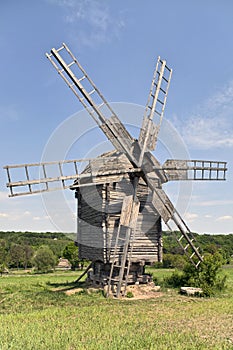 Old wooden windmill on the grassland