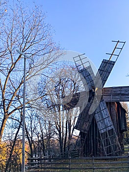 An old wooden windmill. Mill by the water