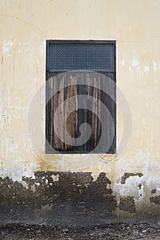 Old wooden window on ancient cement wall,natural color picture style,texture background