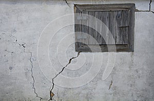 Old wooden window on the background of old plaster.