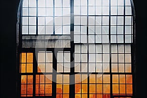 Old wooden window bokeh frame with glass beautifully lit on ruined house wall background. Abandoned building exterior