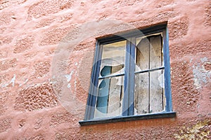 Old wooden window with broken glass