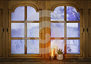 old wooden window, candle burns on windowsill, houseplant succulent, winter landscape behind frosty glass, concept of first Advent