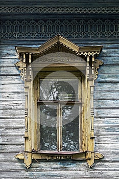 Old wooden window with carved platbands