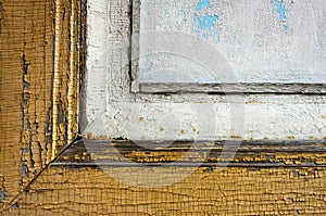 Old wooden window frame with peeling yellow and white paints, retro, vintage