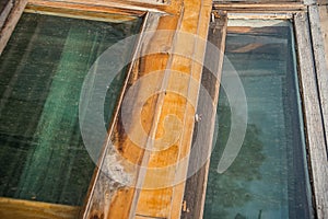 Old wooden window frames with dirty glass. Renovation in room in retro style