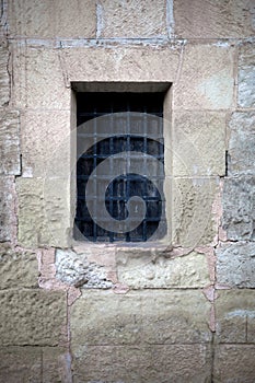 old wooden window with grill in a masonry wall