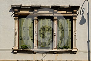Old wooden window with italian style shutters