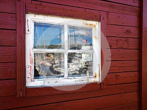 Old wooden window of a red wood house