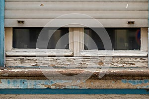 an old wooden window with roller shutters