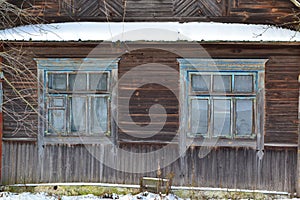 An old wooden window in russian style on a log wall. Traditional old house
