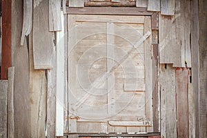 Old wooden window sealed with planks on backdround