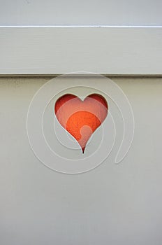 Old wooden window shutter blinder heart shape cut orange photo