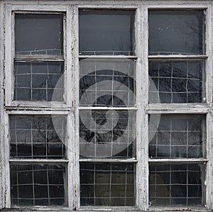 Old wooden window. Vintage frame texture with peeling paint.